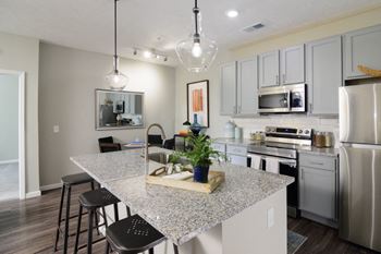 a kitchen with an island and stainless steel appliances at Elan Park, Columbus, OH 